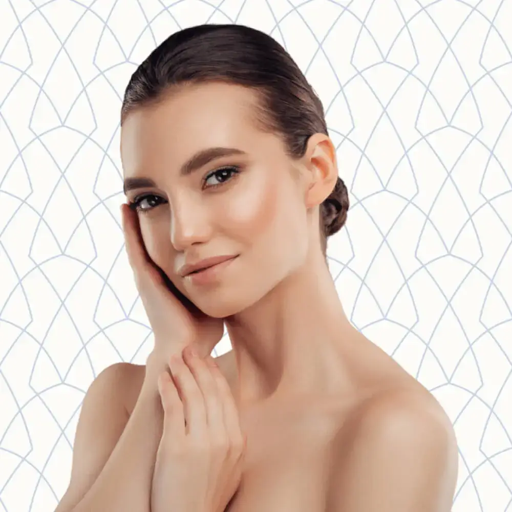 Young woman smiling and posing with a hand on her face | Injectables | Andromeda Medspa